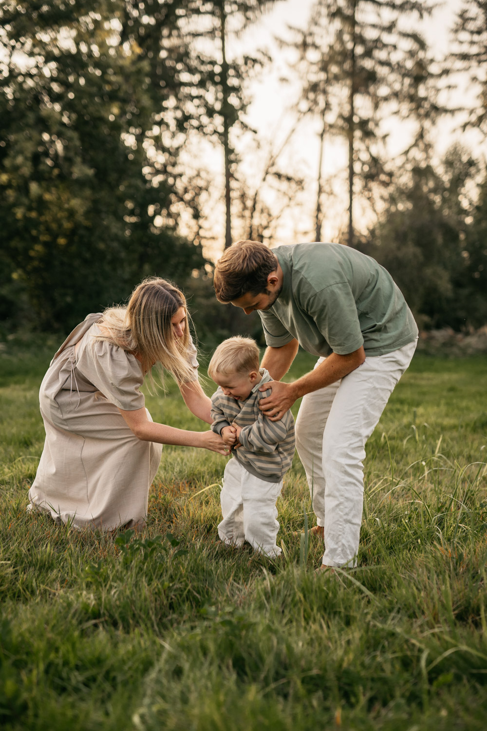 a man and woman tickling a baby