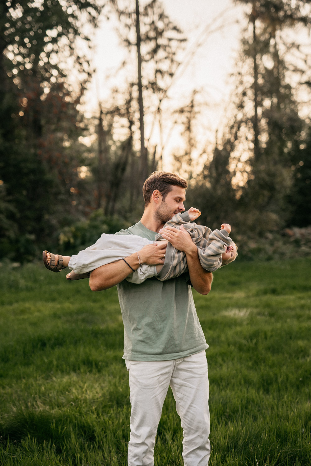 a man holding a baby in his arms